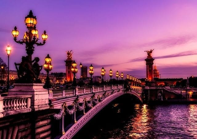 Paris at night with a purple glow. Pont Neuf Bridge